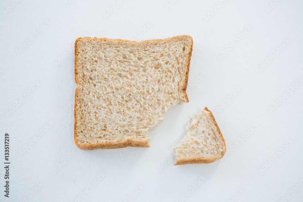 Bread slice with broken edge on white background Bread slice with broken edge on white background