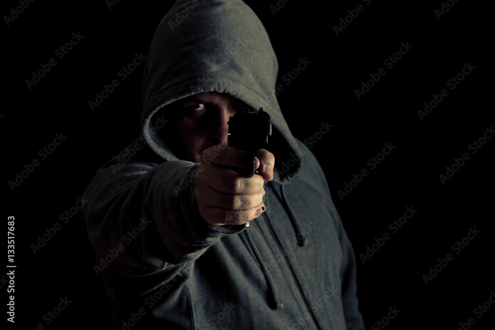 Thug in hoodie points gun Thug in hoodie points gun