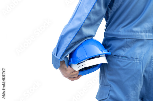 Engineer or worker hold in hand blue helmet for worker security on white background, man wearing a blue bear coat during working at site photo