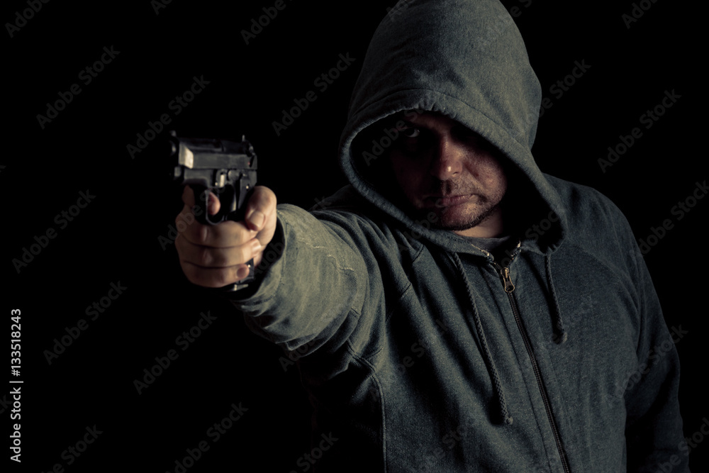 Thug in hoodie points gun Thug in hoodie points gun