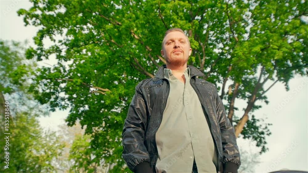 Middle-aged man on a background of spring tree enjoying life Middle-aged man on a background of spring tree enjoying life