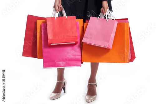 business women carrying colorful shopping bag isolated on white