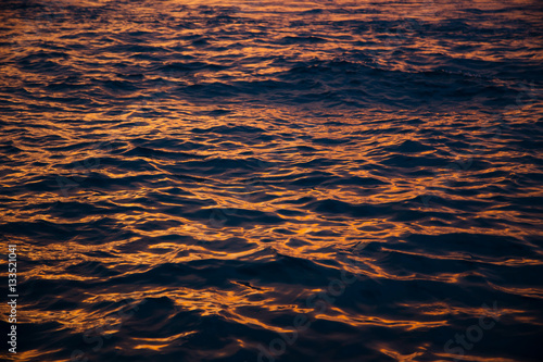 Water waves at golden sunset, sea background