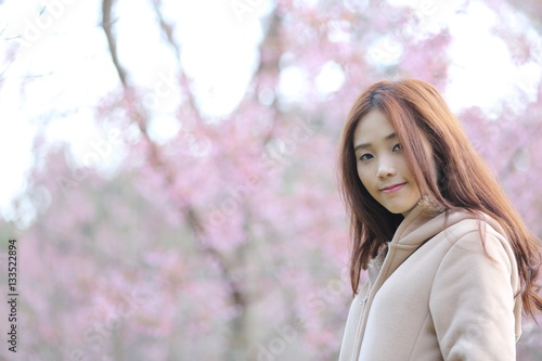 beautiful asian young woman in blooming cherry blossoms sakura