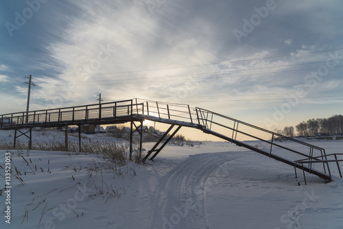 pontoon bridge over the frozen river © faustasyan