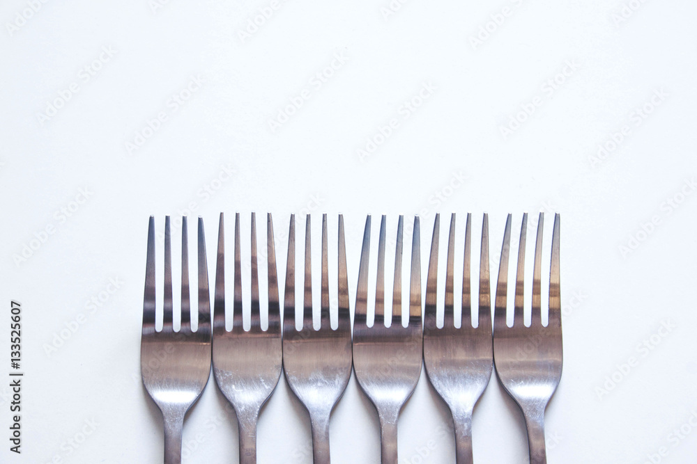 Silver fork neatly on a white table Silver fork neatly on a white table