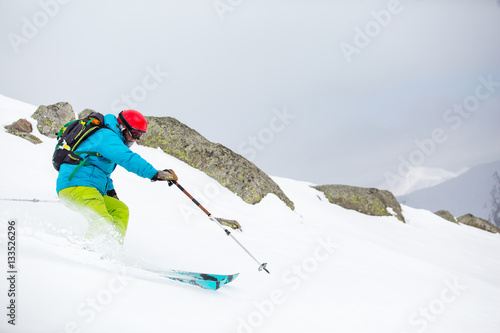 skier skiing on fresh snow on ski slope on Sunny winter day in the ski resort in Georgia