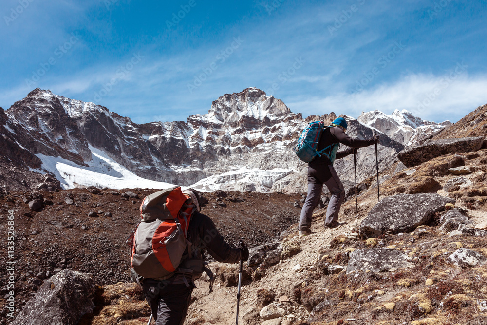 Mountain Climbers Team walking up on rocky Terrain