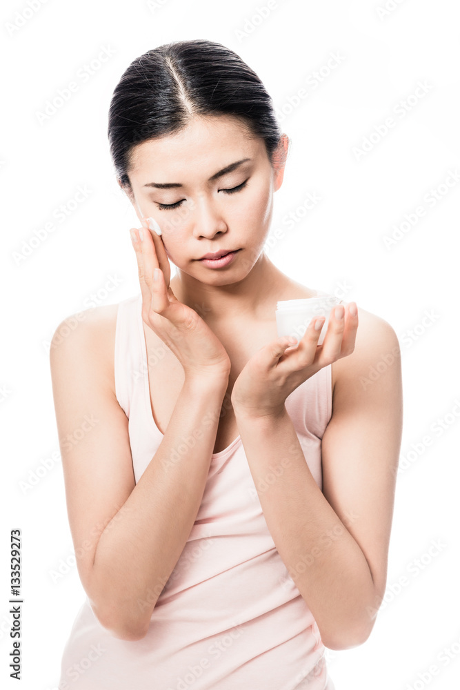 Woman applying facial moisturizer cream for sensitive skin Woman applying facial moisturizer cream for sensitive skin