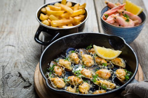 Selection of seafood meal on wood background