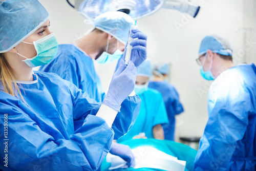 Young surgeon holding a syringe