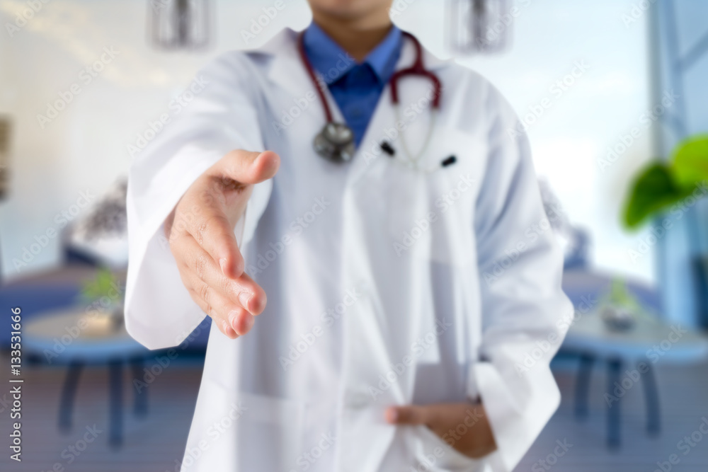 Female doctor giving hand for handshake on blured background Female doctor giving hand for handshake on blured background