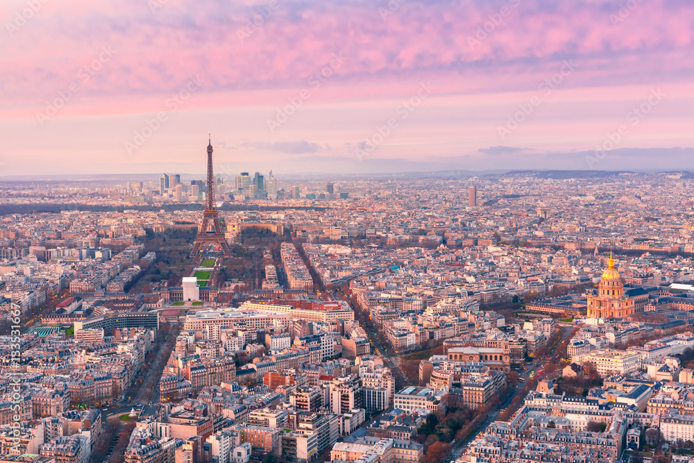 Aerial panoramic view of Paris skyline with Eiffel Tower, Les Invalides and business district of Defense at pink sunset, as seen from Montparnasse Tower, Paris, France