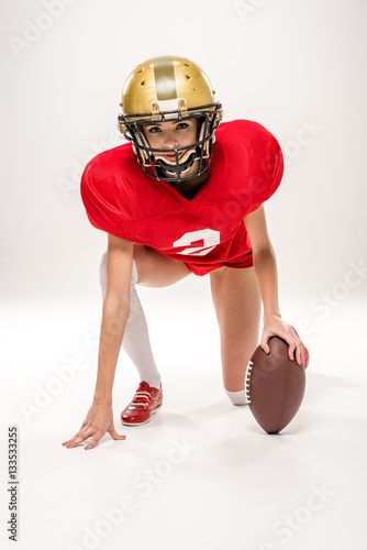american football player posing with ball