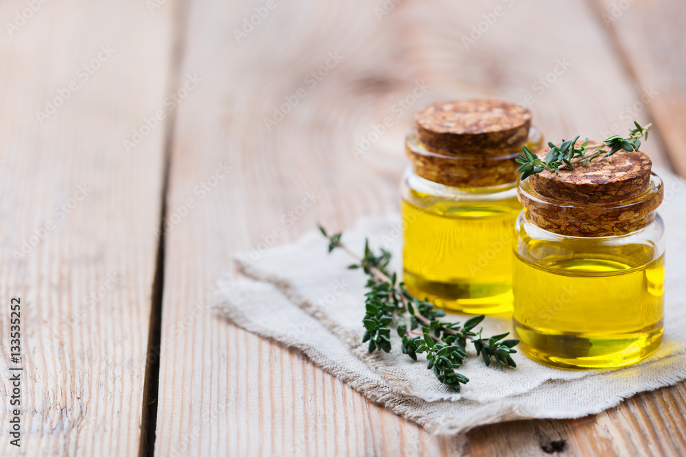 Organic essential thyme oil with green leaves Organic essential thyme oil with green leaves