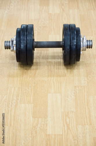 Background with heavy dumbbells on the floor