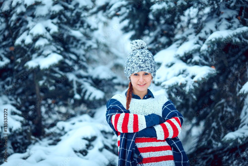 Fototapeta premium winter outdoor portrait of a cute funny positive young girl
