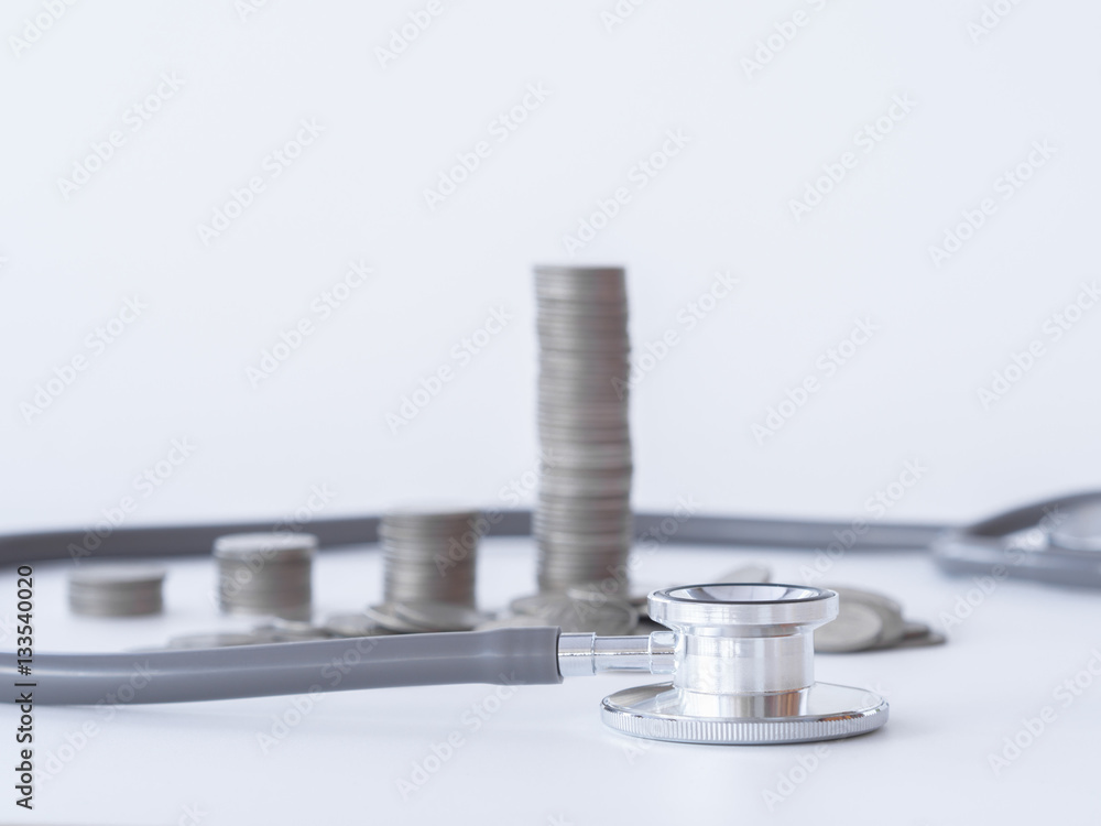 Stethoscope and coin stack on white background. money for health care, Financial Aid, concept. Stethoscope and coin stack on white background. money for health care, Financial Aid, concept.