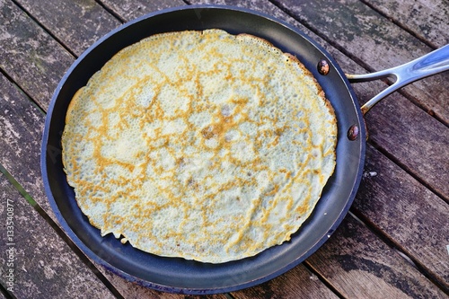 A French crepe just cooked in a flat pan