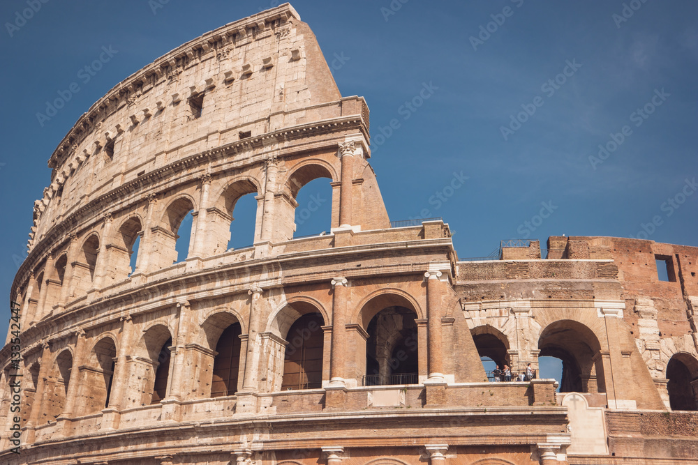 Colosseum on sky background. Arches and walls. Beauty of the old world.