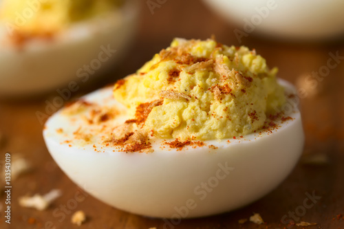 Deviled egg with roasted panko breadcrumbs and paprika powder, photographed with natural light (Selective Focus, Focus one third into the egg yolk)