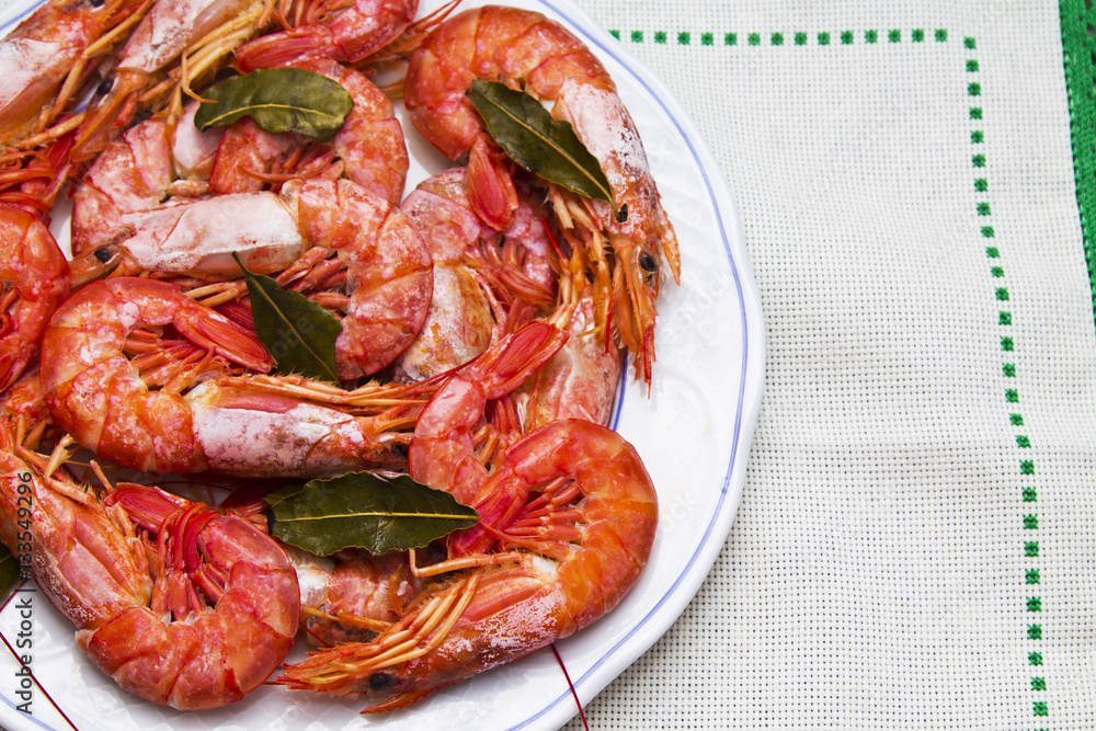 shrimp in the dish on flowered tablecloth shrimp in the dish on flowered tablecloth