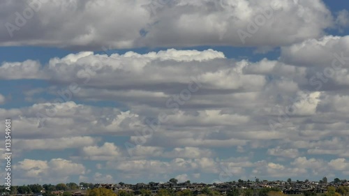 Cumulus Clouds Drift over Surburbs photo