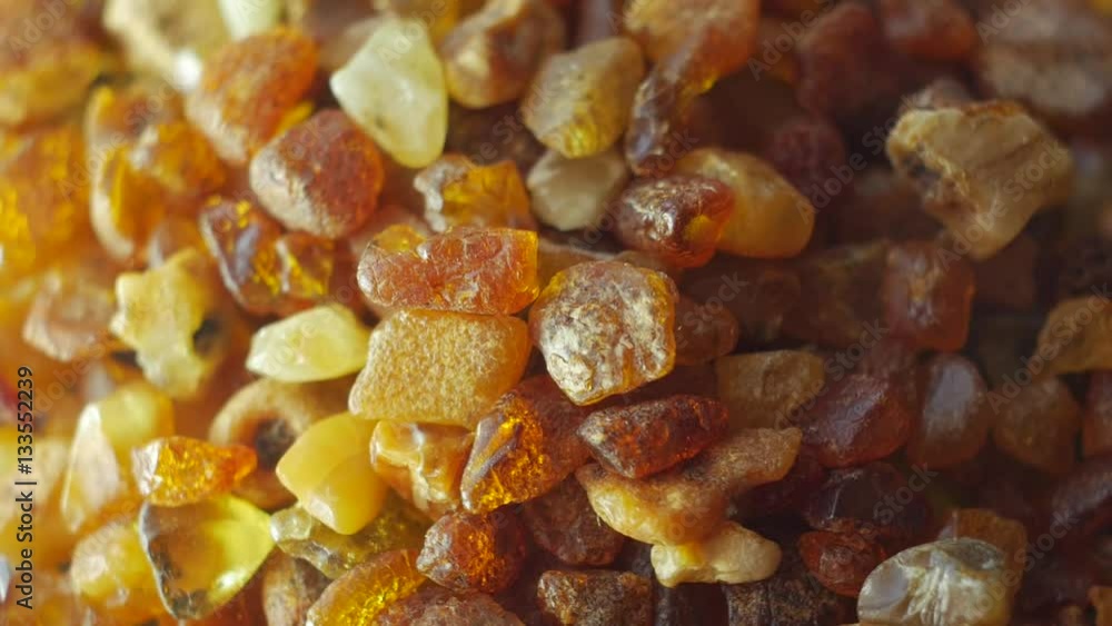 Amber stones from Baltic see on turn table. Macro, slow motion. Amber stones from Baltic see on turn table. Macro, slow motion.