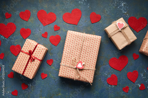 Valentines day background with hearts and a gift boxes on concrete board. Flat lay. Top view table. Packing presents for valentine day, birthday, mother's day or christmas.