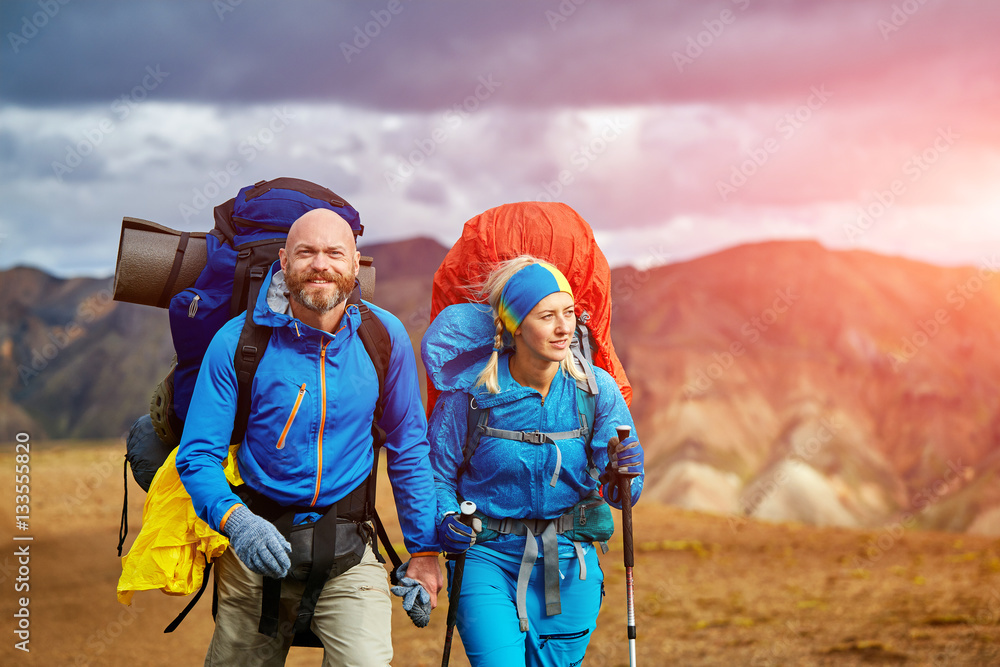 hikers on the trail in the Islandic mountains. Trek in National Park Landmannalaugar, Iceland