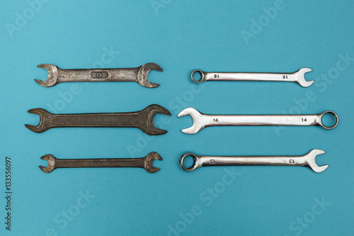 Rusty vintage wrenches isolated on a blue background