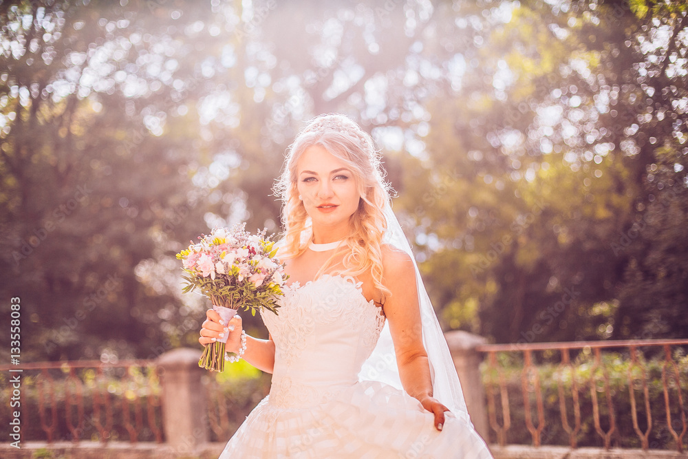 Beautiful bride outdoors in a forest ,meadow sunny day Beautiful bride outdoors in a forest ,meadow sunny day