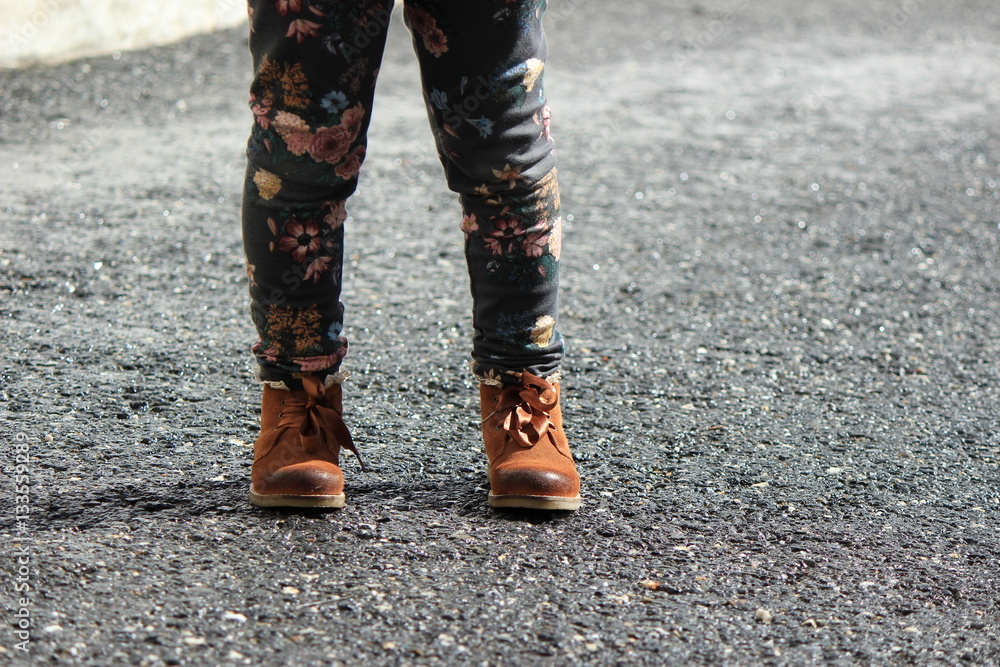 little child girl in jeans with flowers with leather boots little child girl in jeans with flowers with leather boots