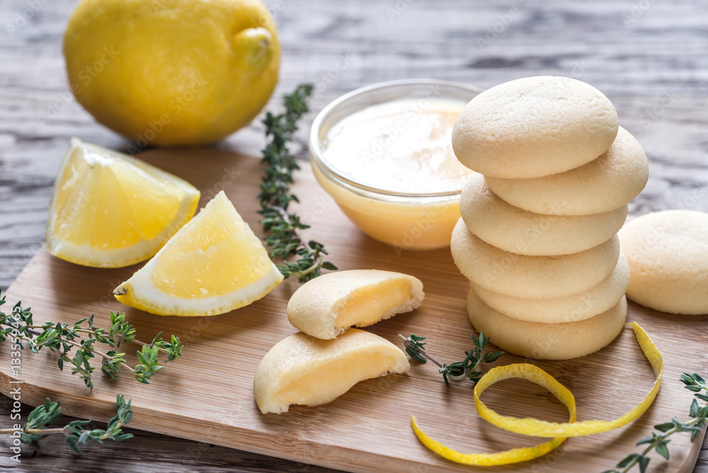 Biscuits filled with lemon cream on the wooden board Biscuits filled with lemon cream on the wooden board