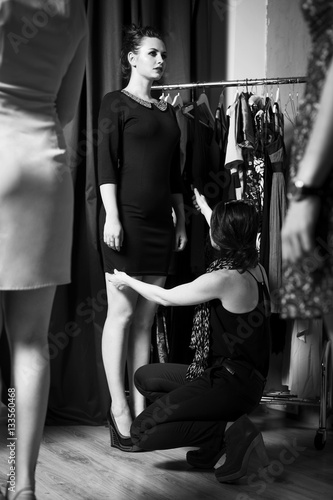 Beautiful plus-size model preparing for a runway show in dress and with make up. Backstage