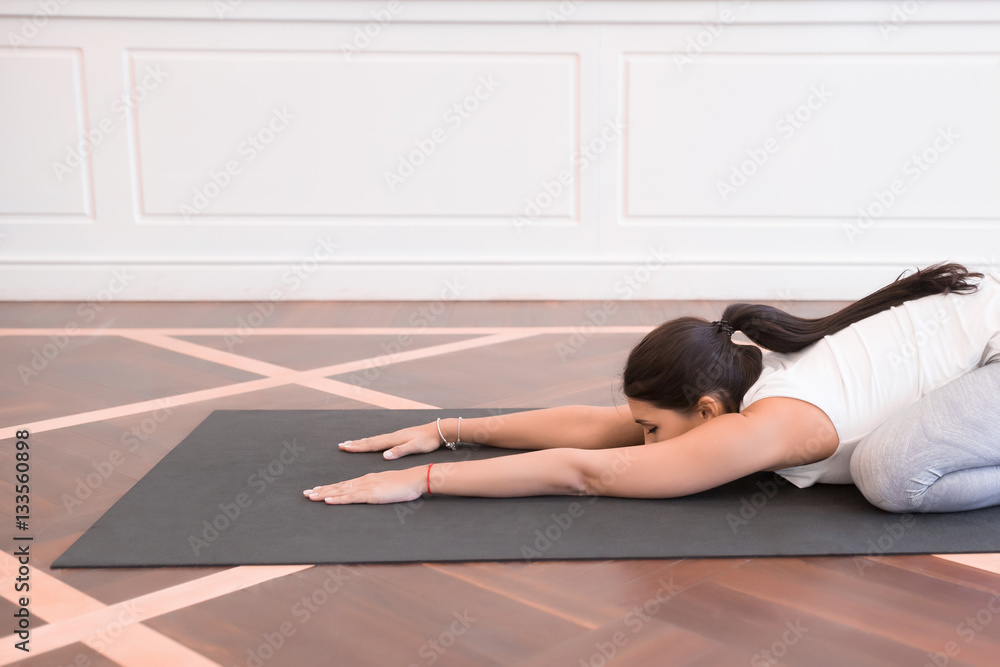 Young man doing an asana ashtavakrasana Young man doing an asana ashtavakrasana