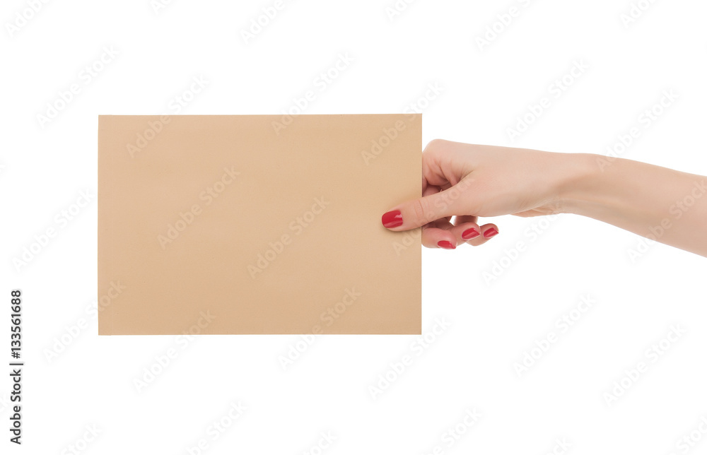 Female hand holds an envelope.