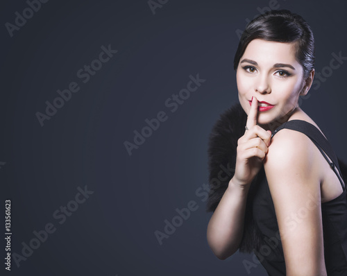 Beautiful Brunette Retro Woman with red lips make up and wave bang hairstyle make shh! Copy Space