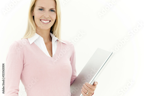 Portrait of a beautiful woman holding a laptop