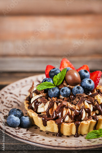 Banoffee chocolate pie decorated with chocolate, fresh blueberry