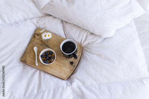 Breakfast in bed with coffee cereals and cranberries