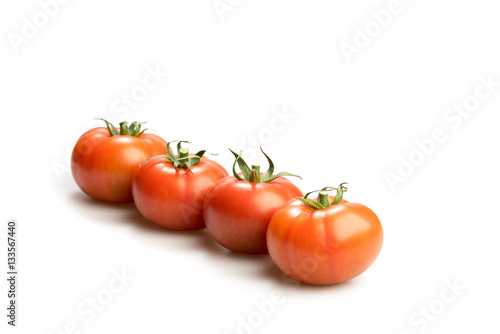 Wallpaper Mural Four realistic looking fresh red tomatoes lying in a line isolated in a white background Torontodigital.ca