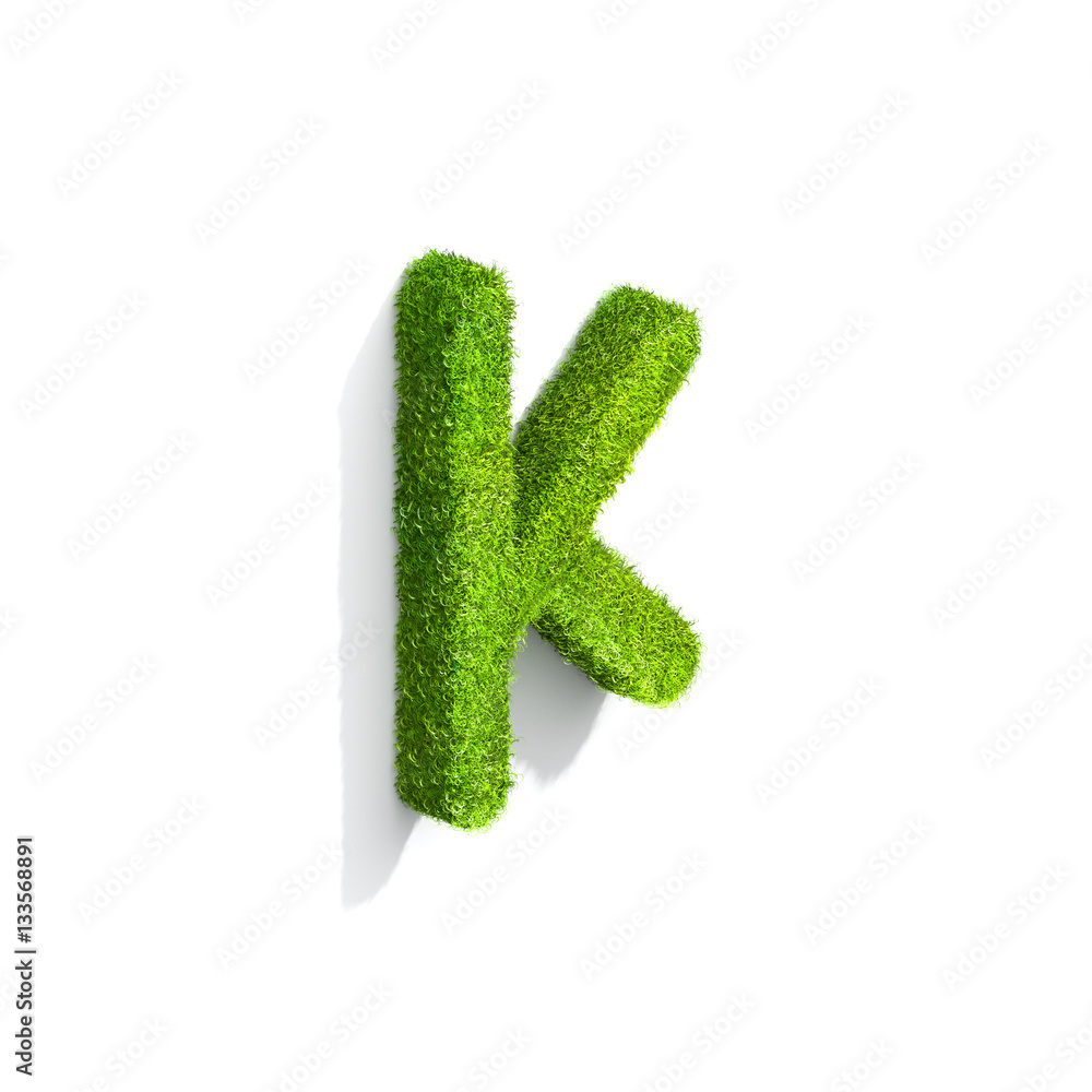 Grass letter K in lowercase format from isometric angle with shadow on ground.