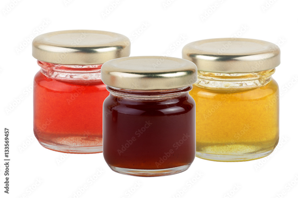 3 jars of multi-colored jams and honey isolated on white background. 3 jars of multi-colored jams and honey isolated on white background.