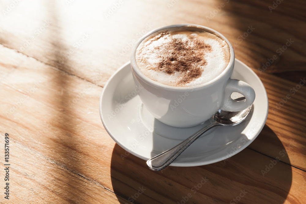 Obraz premium Cup of coffee with milk foam and cinnamon
