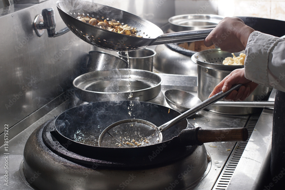 Close up of working chef preparing chinese food Close up of working chef preparing chinese food