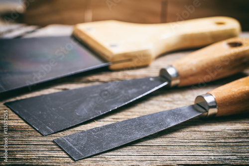 Set of spatulas on wooden background photo