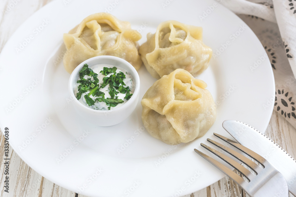 Traditional Turkish manti with sour cream sauce Traditional Turkish manti with sour cream sauce