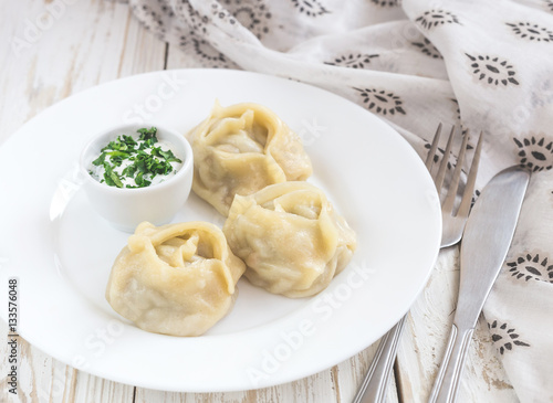 Traditional Turkish manti with sour cream sauce