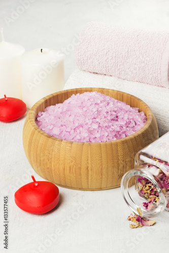 Bath salt with aroma of a rose in a wooden bowl  petals and a fr